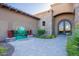 Inviting front entrance with decorative iron door, stone accents, and colorful landscaping enhance curb appeal at 3118 W Glenhaven Dr, Phoenix, AZ 85045