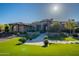 Impressive home with vibrant green lawn, decorative potted plants, and a paved path to the stunning front entrance at 3118 W Glenhaven Dr, Phoenix, AZ 85045