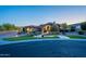 Elegant single-story home featuring lush landscaping, a circular driveway, and an inviting stone facade at 3118 W Glenhaven Dr, Phoenix, AZ 85045