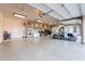 Spacious garage features an epoxy floor, storage shelving, and room for a home gym at 3118 W Glenhaven Dr, Phoenix, AZ 85045