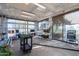 Sunlit greenhouse featuring potting benches, shelving for plants, and sliding glass doors at 3118 W Glenhaven Dr, Phoenix, AZ 85045
