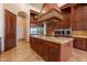 Kitchen island featuring granite countertops, custom cabinetry, and stainless steel appliances at 3118 W Glenhaven Dr, Phoenix, AZ 85045