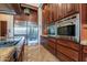 A modern kitchen features stainless steel appliances, custom cabinetry, and sleek countertops at 3118 W Glenhaven Dr, Phoenix, AZ 85045