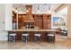 Stylish kitchen island featuring granite countertops, seating, and pendant lighting at 3118 W Glenhaven Dr, Phoenix, AZ 85045