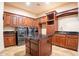 Well-equipped laundry room with front loading washer and dryer and island with black countertops at 3118 W Glenhaven Dr, Phoenix, AZ 85045