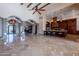 Expansive living area with columns, travertine floors, a kitchen island, and custom ironwork at 3118 W Glenhaven Dr, Phoenix, AZ 85045