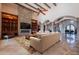 Open concept living room with a stone fireplace, vaulted ceilings, built-in shelves, and large archways at 3118 W Glenhaven Dr, Phoenix, AZ 85045