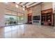 Inviting living room with stone fireplace, built-in shelves, and sliding glass doors to outdoor space at 3118 W Glenhaven Dr, Phoenix, AZ 85045