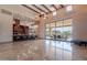 Spacious living room with high ceilings, wood beams, and large sliding glass doors to the outdoor patio at 3118 W Glenhaven Dr, Phoenix, AZ 85045