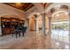 Grand living area with marble floors, columns, piano, and elegant decor offers luxurious comfort and style at 3118 W Glenhaven Dr, Phoenix, AZ 85045