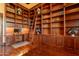 Spacious office with custom wood shelving, hardwood floors, and ample storage to create a productive atmosphere at 3118 W Glenhaven Dr, Phoenix, AZ 85045