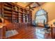 Executive office featuring custom built-ins, wood floors, and a ceiling fan for a comfortable workspace at 3118 W Glenhaven Dr, Phoenix, AZ 85045