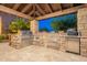 Covered outdoor kitchen and bar with stainless steel grill and refrigerator at 3118 W Glenhaven Dr, Phoenix, AZ 85045