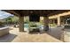 Outdoor kitchen with built-in grill and poolside views near the covered patio for relaxation and entertainment at 3118 W Glenhaven Dr, Phoenix, AZ 85045