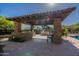 Backyard outdoor kitchen with built-in grill, cooking area, stone facade, covered patio and tiled flooring at 3118 W Glenhaven Dr, Phoenix, AZ 85045