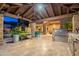 Spacious outdoor kitchen area with stone countertops, stainless steel grill, and a covered patio with a mounted TV at 3118 W Glenhaven Dr, Phoenix, AZ 85045