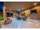 An open-air covered patio with outdoor dining, desert landscaping, and access to the pool and outdoor entertainment at 3118 W Glenhaven Dr, Phoenix, AZ 85045