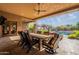 A large dining table on the patio offers a comfortable space for outdoor dining and overlooks the pool at 3118 W Glenhaven Dr, Phoenix, AZ 85045