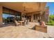 Covered patio featuring a built-in seating area, dining table, and large glass windows for seamless indoor-outdoor living at 3118 W Glenhaven Dr, Phoenix, AZ 85045