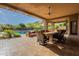 Stylish patio with a dining table and an outdoor lounge area overlooks the pool and landscaped backyard at 3118 W Glenhaven Dr, Phoenix, AZ 85045