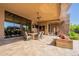 Relaxing covered patio with mountain views includes an outdoor dining and lounge space at 3118 W Glenhaven Dr, Phoenix, AZ 85045