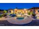 Beautiful pool with a central spa, surrounded by stone decking and lush landscaping for a resort-like feel at 3118 W Glenhaven Dr, Phoenix, AZ 85045