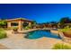 Inviting backyard pool with travertine decking, outdoor kitchen, hot tub and landscaping at 3118 W Glenhaven Dr, Phoenix, AZ 85045