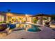 Luxury backyard pool with a spa, stone accents, and an outdoor kitchen, perfect for entertaining at 3118 W Glenhaven Dr, Phoenix, AZ 85045