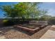 Landscaped backyard featuring raised garden beds, gravel, mature trees and privacy landscaping at 3118 W Glenhaven Dr, Phoenix, AZ 85045