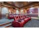 Home theater room with plush red seating and custom wall designs at 3118 W Glenhaven Dr, Phoenix, AZ 85045