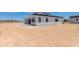The back exterior of this home has a white facade, black trim and large lot at 3335 W Desert Dawn Dr, Phoenix, AZ 85083