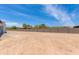 Expansive backyard with block wall fence, desert landscaping, and clear blue sky at 3335 W Desert Dawn Dr, Phoenix, AZ 85083