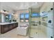 Modern bathroom with a soaking tub, a glass-enclosed shower, and sleek dark wood cabinetry at 3335 W Desert Dawn Dr, Phoenix, AZ 85083