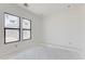 Bright bedroom featuring minimalist design, concrete floor, and two windows at 3335 W Desert Dawn Dr, Phoenix, AZ 85083