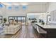 Bright, open-concept living room featuring hardwood floors, a modern kitchen island, and seamless access to the outdoors at 3335 W Desert Dawn Dr, Phoenix, AZ 85083