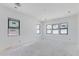 A spacious room with black-framed windows awaits your personal touch, ready for transformation at 3335 W Desert Dawn Dr, Phoenix, AZ 85083