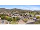 Aerial view featuring homes with tile roofs near a golf course, set against a backdrop of scenic mountains at 3544 N Paseo Del Sol --, Mesa, AZ 85207
