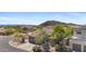 Aerial view of a charming home with desert landscaping and a tile roof, set against a scenic mountain backdrop at 3544 N Paseo Del Sol --, Mesa, AZ 85207