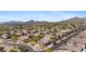 An aerial view showcases a neighborhood nestled amidst desert landscaping and picturesque mountains at 3544 N Paseo Del Sol --, Mesa, AZ 85207