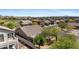 Aerial view showcasing homes with tile roofs in a desert community near a golf course and mountain views at 3544 N Paseo Del Sol --, Mesa, AZ 85207