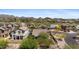 Aerial view showcasing homes with tile roofs near a golf course, amidst desert landscaping and mountain scenery at 3544 N Paseo Del Sol --, Mesa, AZ 85207