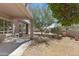 Charming backyard featuring a covered patio, desert landscaping, and mature trees adding shade and character at 3544 N Paseo Del Sol --, Mesa, AZ 85207