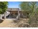 Backyard showcasing covered patio with seating, desert landscaping, and mature trees for shade and privacy at 3544 N Paseo Del Sol --, Mesa, AZ 85207