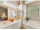 Bright bathroom with soaking tub, double sinks, and a glass block window to let light stream through at 3544 N Paseo Del Sol --, Mesa, AZ 85207