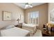 Comfortable bedroom with a ceiling fan, two twin beds, and plantation shutters at 3544 N Paseo Del Sol --, Mesa, AZ 85207