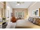 Relaxing bedroom with a plush bed, bay windows with shutter-style blinds, and a cozy reading chair at 3544 N Paseo Del Sol --, Mesa, AZ 85207