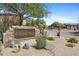 Rolling Hills community entrance with stone sign, desert landscape, and secured gate at 3544 N Paseo Del Sol --, Mesa, AZ 85207