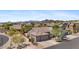 Aerial view showcases a desert home with a three-car garage and desert landscaping at 3544 N Paseo Del Sol --, Mesa, AZ 85207