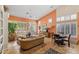 Bright living room featuring a dining table, tan sofa, and large windows with white shutters and vibrant walls at 3544 N Paseo Del Sol --, Mesa, AZ 85207