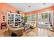 Well-lit living room featuring a tan sofa, decorative bookshelf, and large windows with white shutter-style blinds at 3544 N Paseo Del Sol --, Mesa, AZ 85207